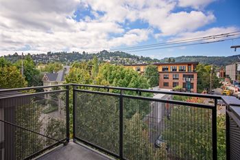 a balcony with a view of the city and trees